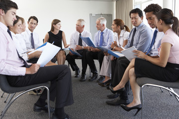 Wall Mural - Businesspeople Seated In Circle At Company Seminar