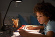 © Monkey Business - Young Boy Studying At Desk In Bedroom In Evening