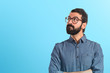 © luismolinero - Young hipster man thinking over white background