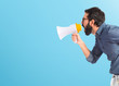 © luismolinero - Young hipster man shouting by megaphone