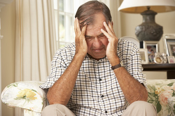 Wall Mural - Unhappy Retired Senior Man Sitting On Sofa At Home