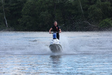 Action Photo Young Woman On Jet Ski.
