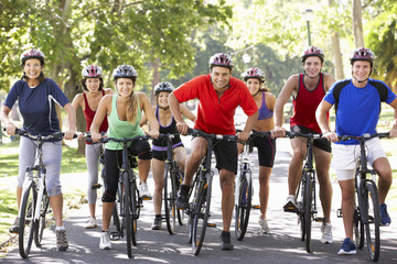 Group Of Cyclists On Cycle Ride Through Park