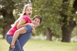 © Monkey Business - Young Man Giving Woman Piggyback On Walk Through Countryside