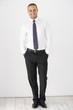 © Monkey Business - Studio Portrait Of Businessman Standing Against White Background