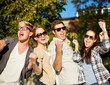 © Syda Productions - group of happy friends showing triumph gesture