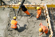 © fotoember - Street workers pouring cement with a pump into a highway constru