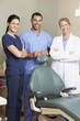 Portrait Of Dentist And Dental Nurses In Surgery