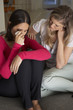 © Monkey Business - Woman Sitting On Sofa Comforting Unhappy Friend