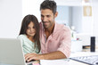 © Monkey Business - Man Working At Laptop With Daughter In Home Office