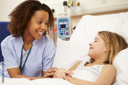 Fotografie, Obraz Nurse Sitting By Young Girl's Bed In Hospital