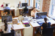 © Monkey Business - Wide Angle View Of Busy Design Office With Workers At Desks