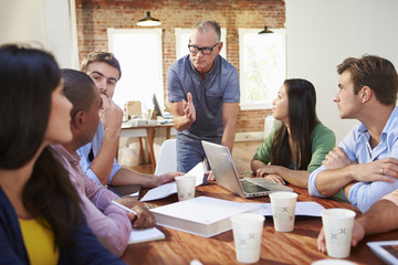 Wall Mural - Group Of Office Workers Meeting To Discuss Ideas