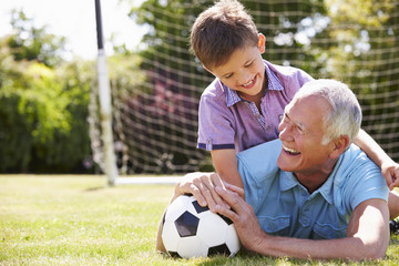 Wall Mural - Portrait Of Grandfather And Grandson With Football