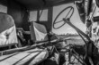 Black and white interior of WW2 Jeep with rifle across seat.