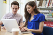 © Monkey Business - Two University Students Working In Library Using Laptop