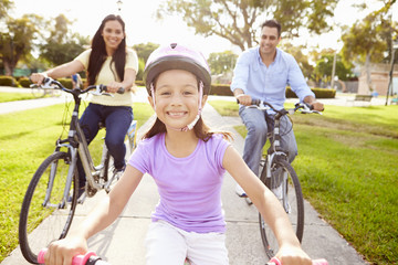 Wall Mural - Parents With Daughter Riding Bikes In Park