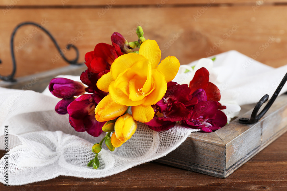 Beautiful spring flowers on wooden background