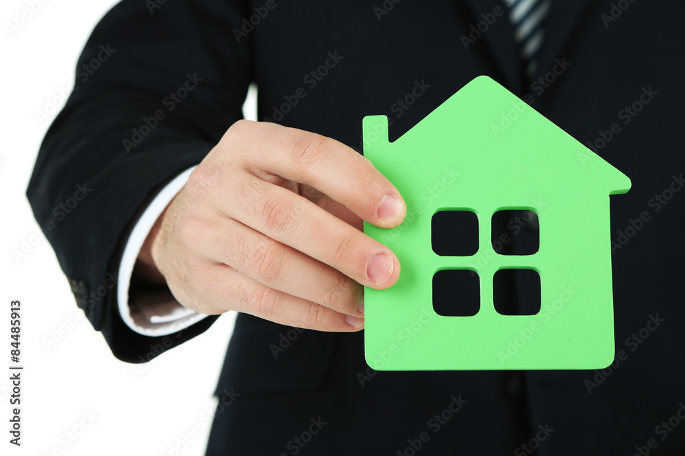Male hand with model of house, closeup