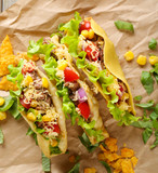 Fototapeta Tęcza - Tasty taco with greens on paper close up