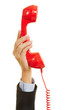 © Robert Kneschke - Hand hält rotes Telefon für Notruf