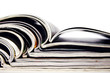 Pile of magazines with open pages on a white background