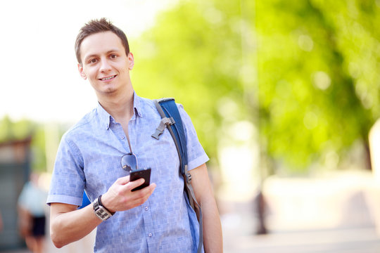 Close up portrait of a young man with phone