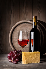 Wall Mural - Glass of red wine and cheese with a bottle