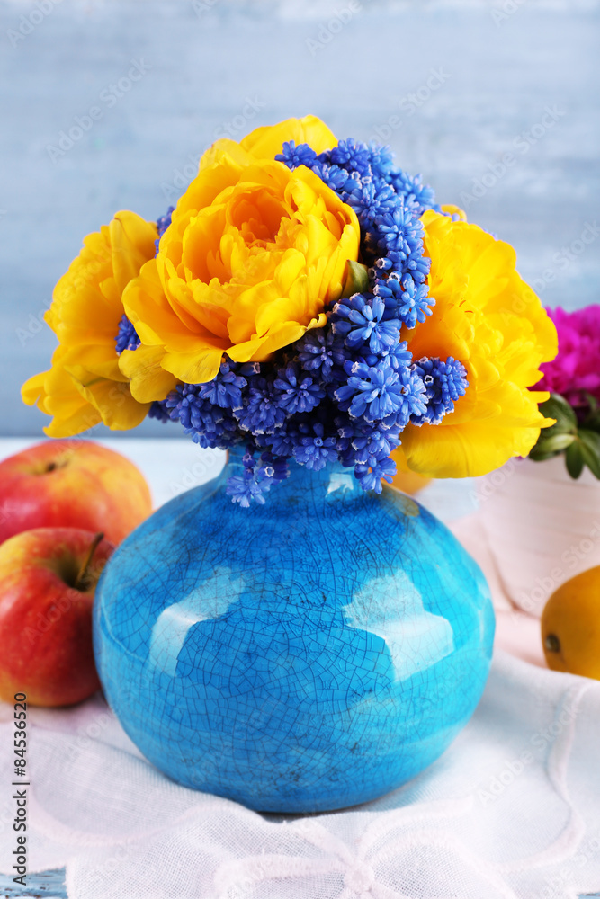 Composition with fresh spring flowers on wooden background