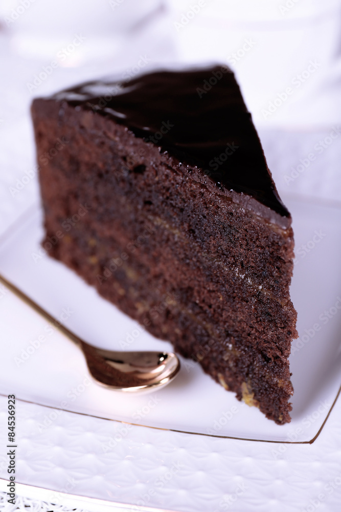 Piece of chocolate cake on white plate, closeup