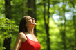 Woman breathing fresh air in the forest