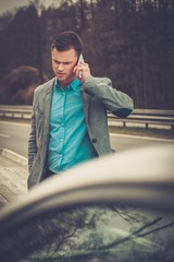 Wall Mural - Man calling while tow truck picking up his broken car