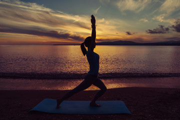 Wall Mural - Girl doing yoga exercise on beach