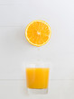 Orange dripping juice over a orange juice glass