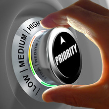 Hand Rotating A Button And Selecting The Level Of Priority.