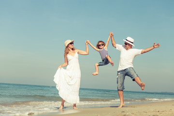 Wall Mural - Happy family playing on the beach at the day time.