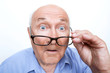 Surprised grandfather holding glasses