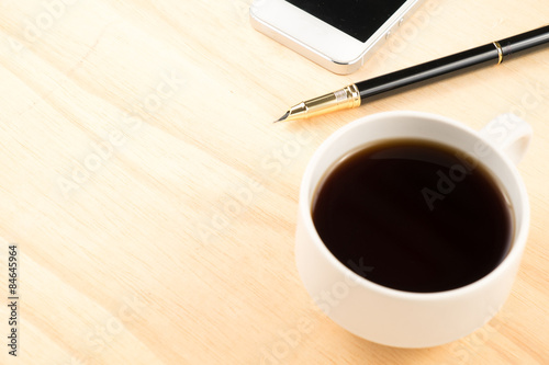 Obraz Dibond black coffee pen and smartphone on wooden table