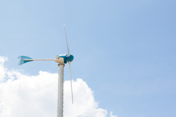 Side of Windmills for electric generator with blue sky and white