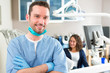 © Production Perig - Portrait of a young attractive dentist in his office