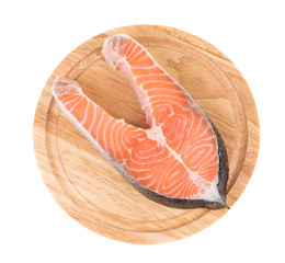 Sticker - Raw salmon steak on cutting board.