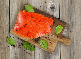 Wall Mural - Cold smoke red salmon being prepared on wooden server board