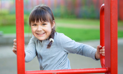 Wall Mural - Cute little girl is playing in playground