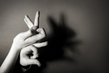Hands Gesture Like Hare On Gray Background