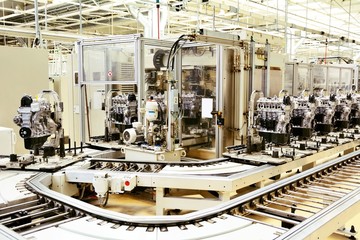 Automated production assembly line with manufactured car engines in the car factory. Car factory. Car parts. Engine factory.