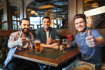 Wall Mural - happy male friends drinking beer at bar or pub