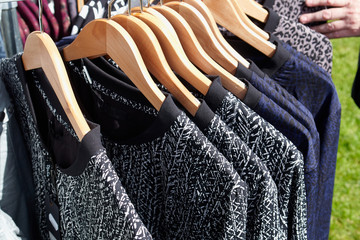 Fashionable blouses on hanger rack display