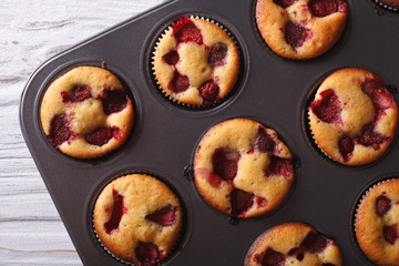 Wall Mural - strawberry muffins close-up in baking dish horizontal top view 
