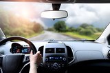 Fototapeta Sport - Driver's hands on steering wheel inside of a car