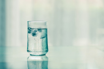 Wall Mural - glass of Cool fresh drink with ice cube on the  table